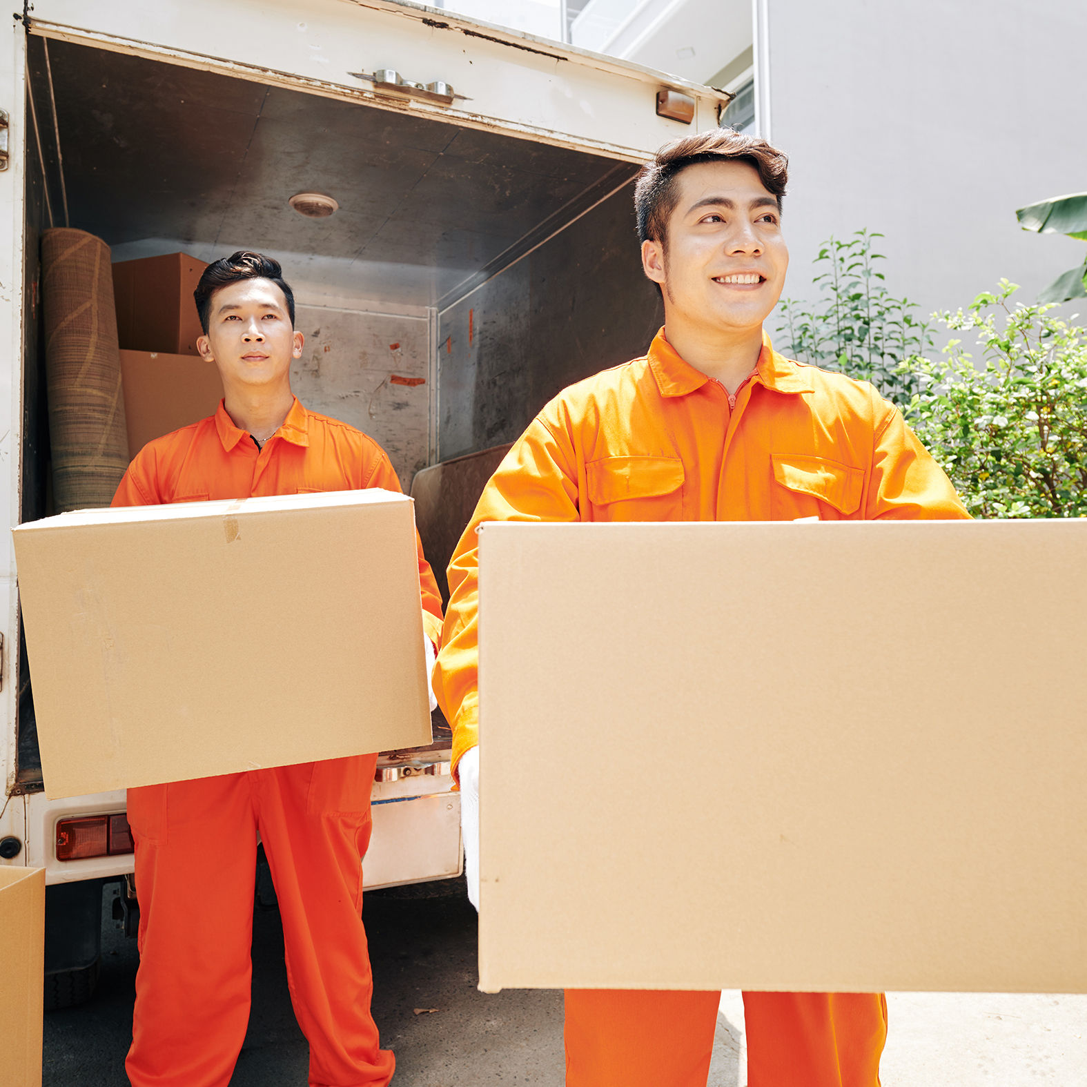workers carrying cardboard boxes