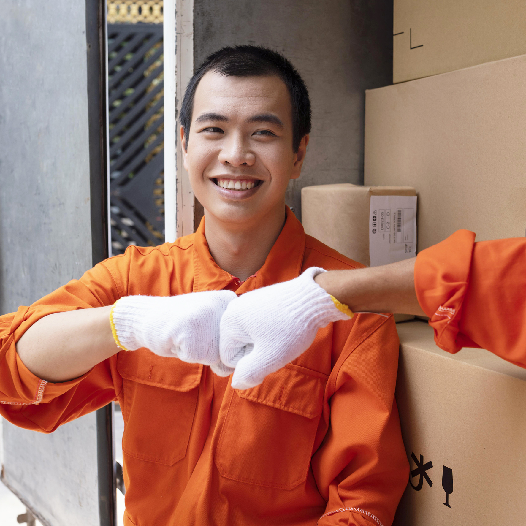 young delivery men saluting each other with fist bump