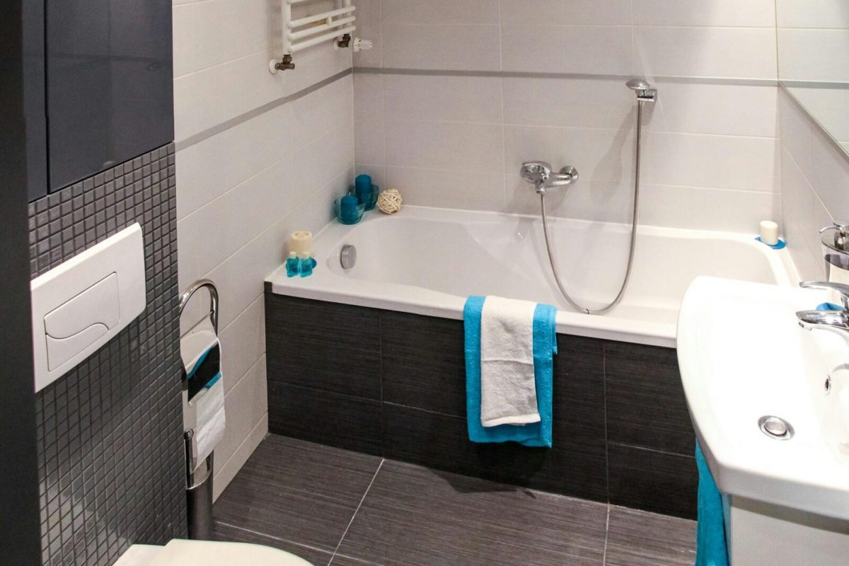 Contemporary bathroom featuring a sleek white bathtub, modern fixtures, and minimalist interior design.